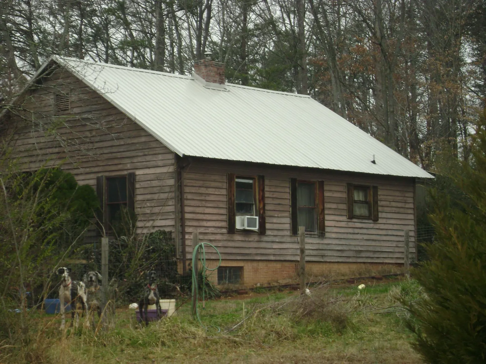 White metal roof on an old wood sided farmhouse, from a Metal Roof Installation job in Elberfeld